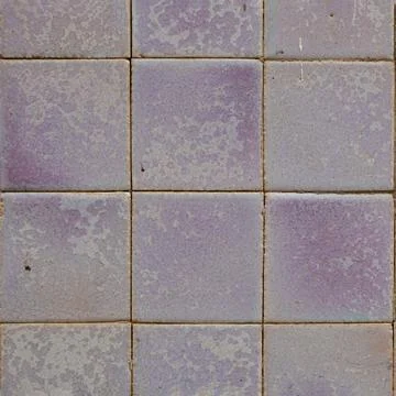 A close-up view of square tiles in various soft lavender hues Stock Photos