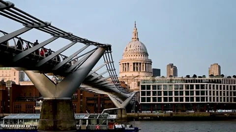Close view of St Paul's Cathedral over the Millennium Bridge and a Boat Stock Footage 299983252