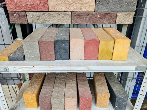 Close up view of a stack of bricks displaying various shades of red and gray. Stock Photos