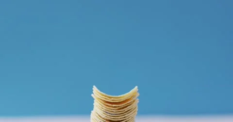Close up view of stack of potato chips with copy space against blue background Stock Footage 191098868