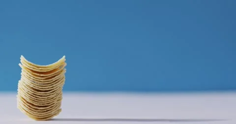 Close up view of stack of potato chips with copy space against blue background Stock Footage 340985861
