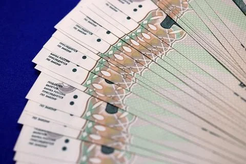 A close-up view of stacked banknotes arranged in a fan shape, showcasing in.. Stockfoto's