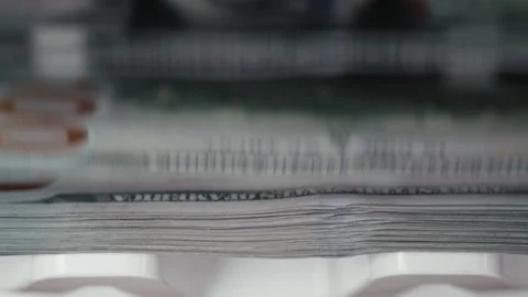 Close-up view of stacked banknotes being processed in a currency counting Stock Footage 331080014