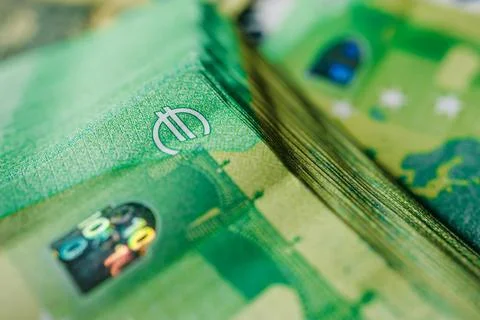 Close-up view of stacked banknotes featuring intricate designs and security.. Stock Photos