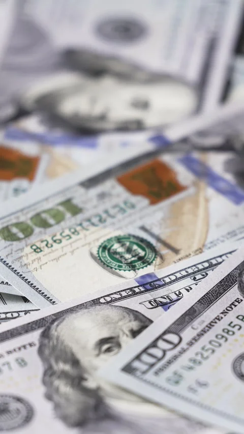 Close-up view of stacked hundred-dollar bills showing detailed designs, colors, Stock Footage 328124754