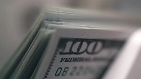 Close-up view of stacked hundred-dollar bills showing detailed texture and Stock Footage 331080206