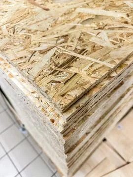 Close-up view of stacked oriented strand board OSB wood sheets for construction Stock Photos