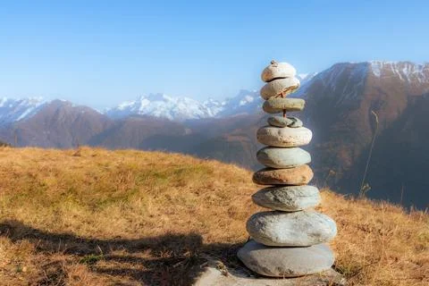 Close up view of a stacked stone tower in a mountains landscape. Stock Photos