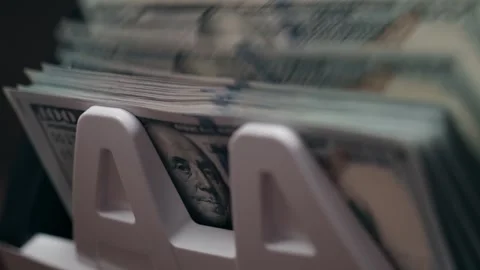 Close-up view of stacks of U.S. currency in a white money holder, showcasing the Stock Footage 333979198