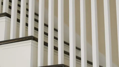Close up view of staircase with white vertical rails creating pattern of lines Stock Footage 275906978