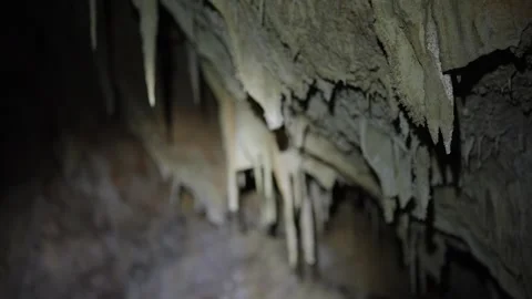 Close up view of stalactites within a dark cave Stock Footage 346101658