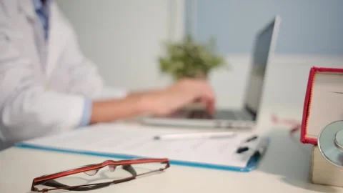 Close up view of stethoscope with books on table and female doctor Stock Footage 251941648