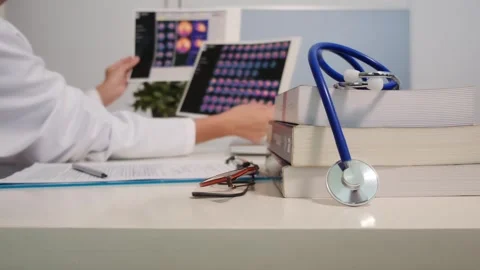 Close up view of stethoscope with books on table and female doctor 스톡 동영상 251942088