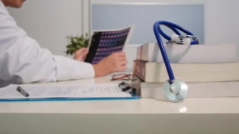 Close up view of stethoscope with books on table and female doctor 스톡 동영상 251942126
