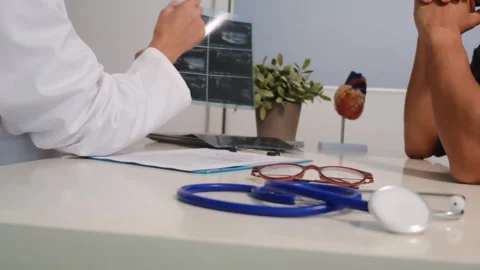 Close up view of stethoscope with books on table and female doctor Stock Footage 251942356