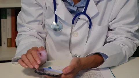 Close up view of stethoscope with books on table and female doctor 스톡 동영상 251942360