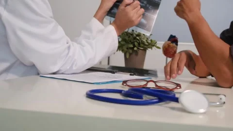 Close up view of stethoscope with books on table and female doctor Stock Footage 251942362
