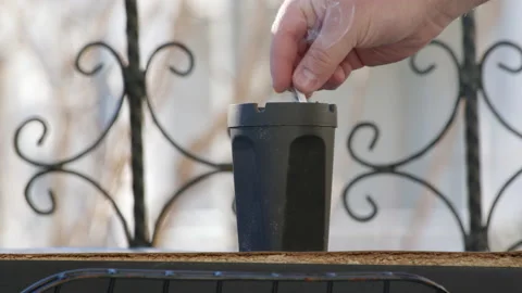 Close up view of stewing ham in black ashtray on balcony. end of extinguishing Stock Footage 233044570