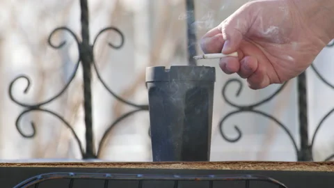 Close up view of stewing ham in black ashtray on balcony. end of extinguishing Stock Footage 233325537
