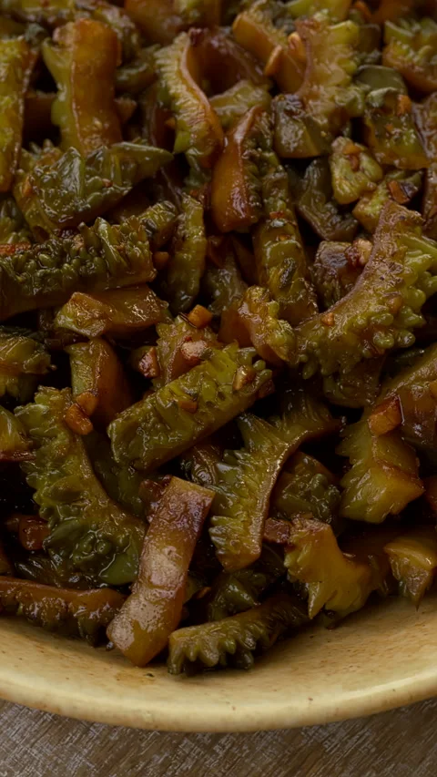 Close-up view of stir fried bitter melon. Vertical video. Stock Footage 284087286