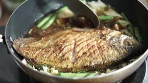 Close-up view of stir-fried gourami fish Stock Footage 261249378