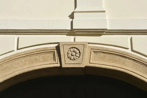 Close up view of a stone arch with a carved flower rosette keystone Stock Photos