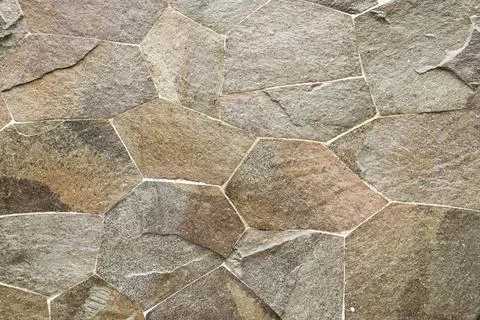A close up view of a stone background, showcasing its rough and textured su.. Stock Photos