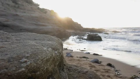 Close-up view of stone on the beautiful beach at sunset Stock Footage 129629666