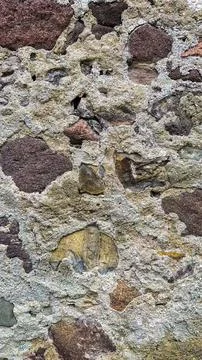 Close-up view of stone wall's texture and hues, emphasizing its sturdy Stock Photos