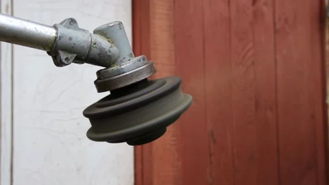 Close up view of string trimmer head with rapidly rotating cutting line engaged 库存影片 329621682