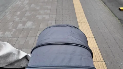 A Close-Up View of a Stroller on a City Path Stock Footage 313834792