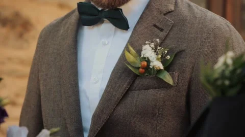 Close up view of a stylish guy's jacket and wedding boutonniere Stock Footage 220558717