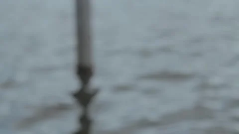 Close-Up View of Submerged Pole in Calm Water with Gentle Ripples and Refle.. Stock Footage 303340181