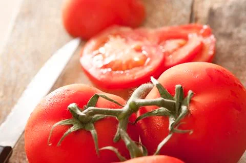 Close up view of succulent red tomatoes on vine Stock Photos