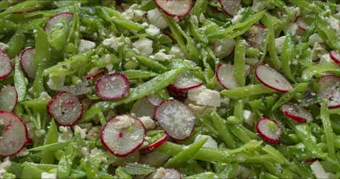 Close-up view of sugar snap pea and radish salad. Stock Footage 312330200