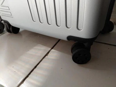 Close-up view of suitcase wheels on the bottom, highlighting durable travel lugg Stock Photos