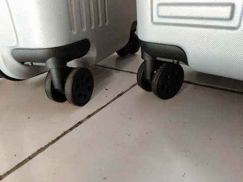 Close-up view of suitcase wheels on the bottom, highlighting durable travel lugg Stock Photos