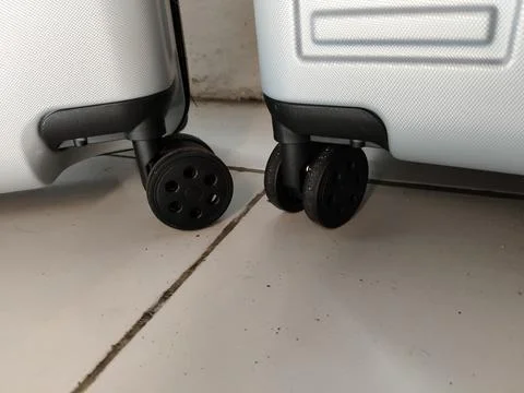 Close-up view of suitcase wheels on the bottom, highlighting durable travel lugg Stock Photos