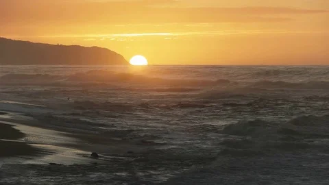 Close view of the sun setting at kaena point in hawaii Video stock 83385064