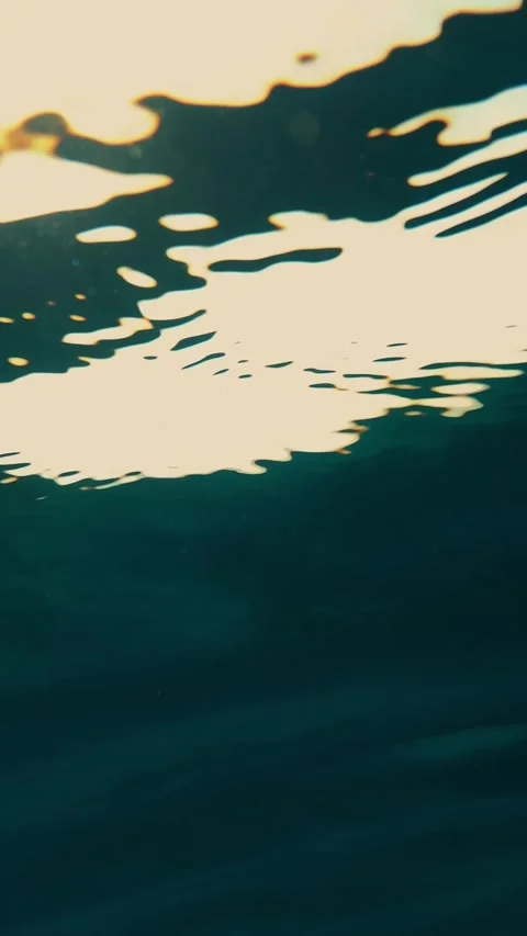 Close-up view of the sun under the water, through a layer of water. Underwater Stock Footage 319657141
