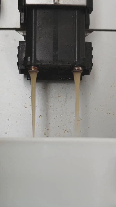 Close up view of a super automatic coffee machine dispensing a freshly brewed Видео 341140303