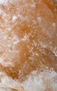 Close-up view of the surface of an amber-colored stone made of mineral salt Stock Photos