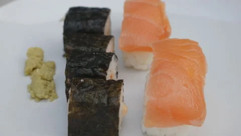 A close up view of sushi rolls, sashimi and wasabi. Stock Footage 129874605