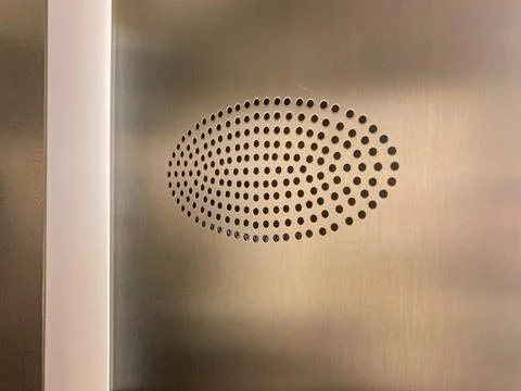 Close-up view of a symmetrical, circular dot pattern designlogo against a neu Stock Photos