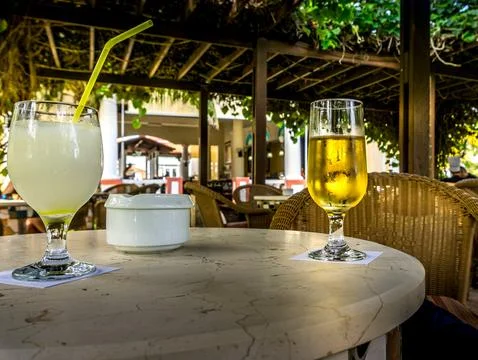 Close view of a table and filled glasses, inside a restaurant in Cuba Stock Photos