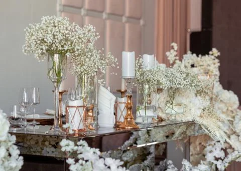 Close view table with floral decor. Modern decor in expensive tones Stock Photos