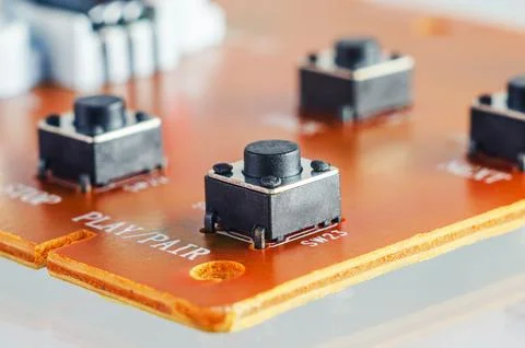 Close-up view of tactile push buttons on a printed circuit board with label.. Stock Photos
