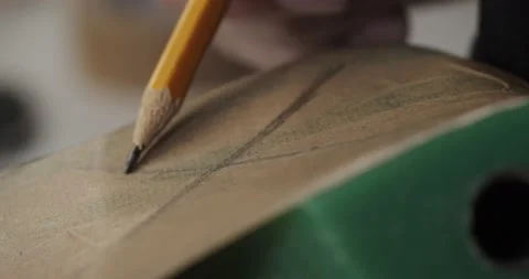Close up view of tailor draws a sketch on a shoe blank with pencil in private Stock Footage 200127880