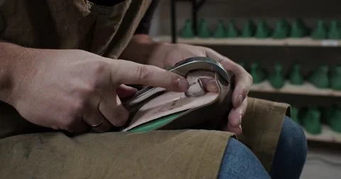 Close up view of tailor nailing and fixing blank for shoes in private leather Stock Footage 200127656