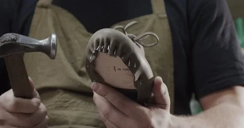 Close up view of tailor nailing and fixing blank for shoes in private leather Stock Footage 200127703